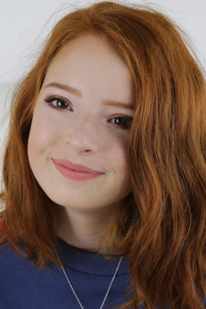 Headshot portrait of happy ginger red hair girl with 