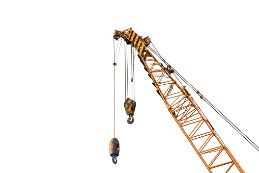 Close-up industrial big crane with steel hook for work on construction building outdoor site, isolated on white background