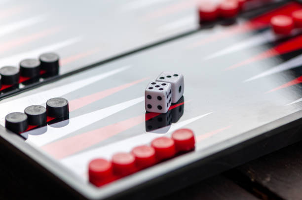 Close-up of a backgammon table Close-up of a backgammon table. Focus on the dice. backgammon stock pictures, royalty-free photos & images