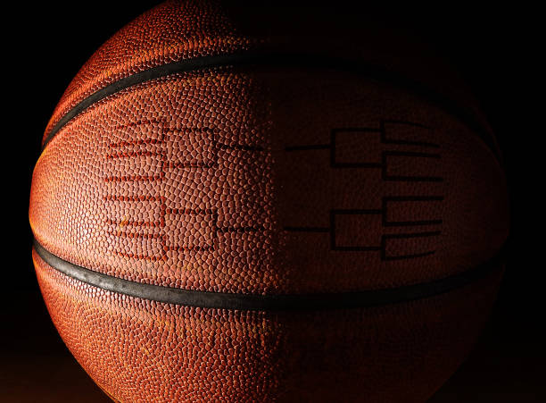 Closeup of a basketball with a tournament bracket stock photo