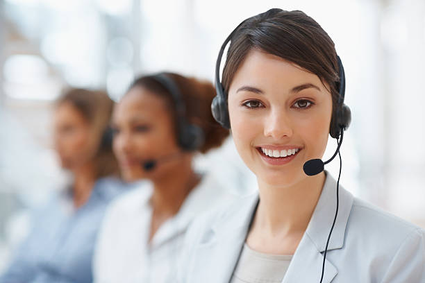 Closeup of a call center employee with headset at workplace Closeup of a cute business woman with headset at workplace call center photos stock pictures, royalty-free photos & images