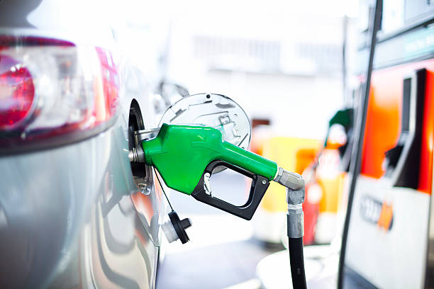 A close-up of a car being filled with gas filling gas at a gas station oil  stock pictures, royalty-free photos & images