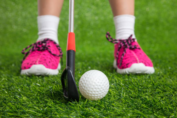 Closeup of a child golfer with putter and ball Closeup of a child golfer with putter and ball putting on green grass asian girls feet stock pictures, royalty-free photos & images