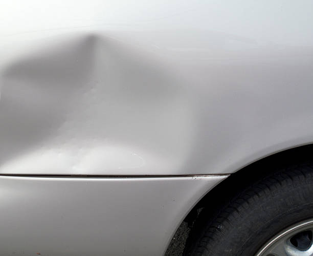 Close-up of a dent in a gray car exterior stock photo