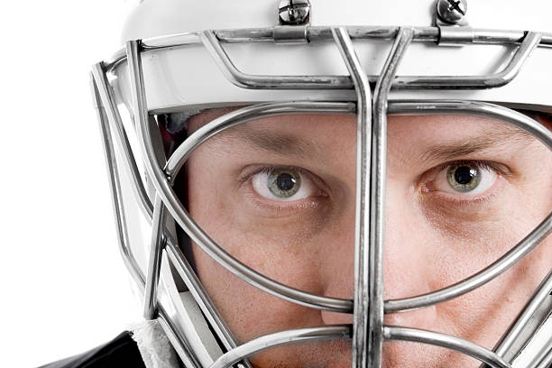 Close-up of a focused hockey goalie behind his mask stock photo