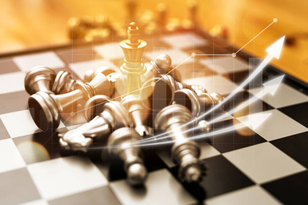 Close-up of a game of chessboard with chess pieces. Chessboard Concept vs. Business Management on Risk, Graphic Charts Showing Financial Flows and Business Performance. Risk management. stock photo