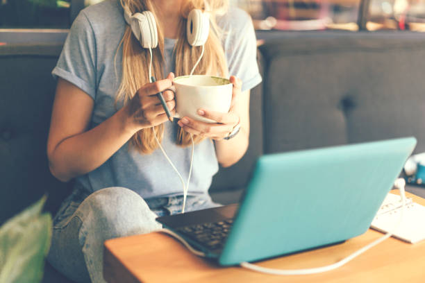 Close-up of a girl with headphones and a laptop stock photo