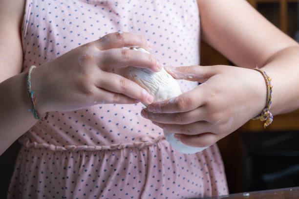 Close-up of a girl's hands making a clay figure. children's crafts stock photo
