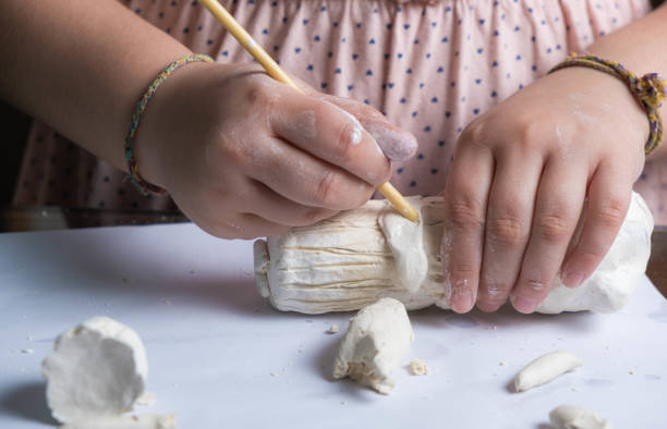 Close-up of a girl's hands making a figure with clay. children's crafts stock photo