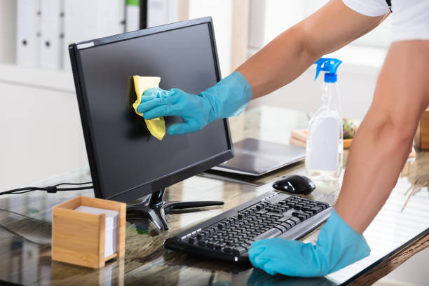 Close-up Of A Janitor Cleaning Computer Screen Close-up Of A Janitor's Hand Wearing Gloves Cleaning Computer Screen With Rag Office cleaning stock pictures, royalty-free photos & images