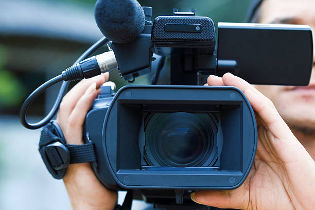 Close-up of a male videographers black camera stock photo
