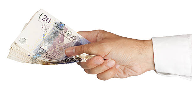 Close-up of a person holding cash in their hand stock photo