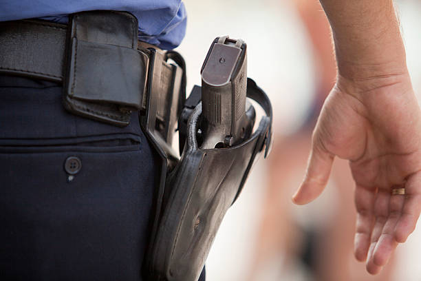 close-up of a police officer's service revolver - gun stok fotoğraflar ve resimler