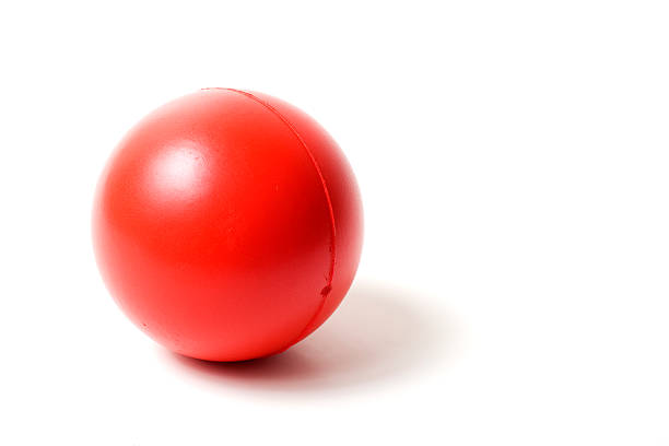 Close-up of a red rubber stress ball on white background stock photo