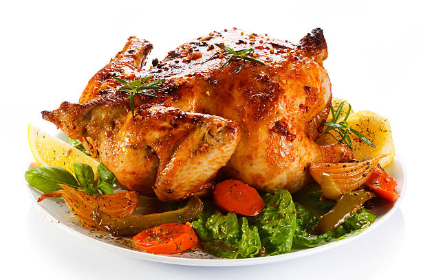 Close-up of a roasted chicken with vegetables stock photo