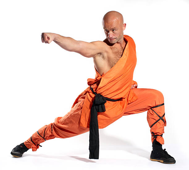 Close-up of a Shaolin Warrior monk training in orange stock photo