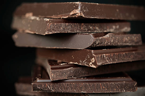 A close-up of a stack of dark chocolate Chocolate Bars Close up chocolate stock pictures, royalty-free photos & images