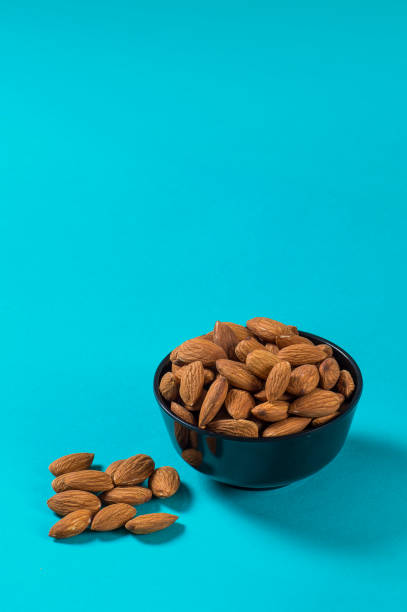 Close-up of Almonds on blue background stock photo