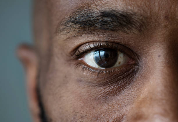 Closeup of an eye of a black man stock photo