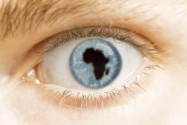 A close-up of an eye with the pupil in the shape of Africa.