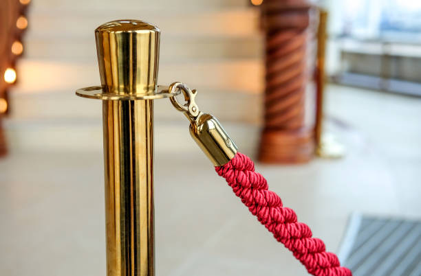 close-up of an old-colored barrier with red cord in a luxurious foyer - ropes backstage theater imagens e fotografias de stock