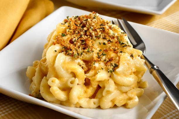 Close-up of baked macaroni and cheese on white plate stock photo