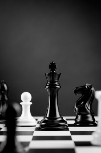 Closeup Of Black Chess King Among Other Figures On Chessboard Stock Photo Download Image Now Istock