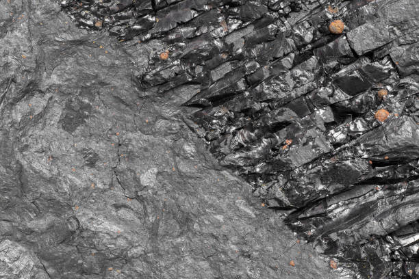 Closeup of black coal rock cross-section texture. Unclean energy source stock photo