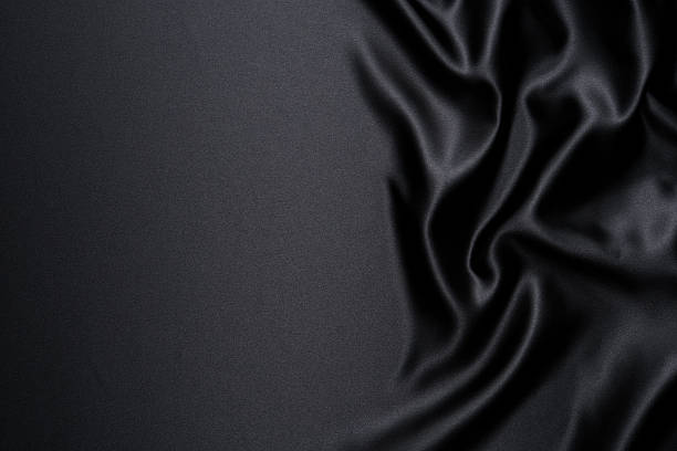 Close-up of black satin wave background with copy space stock photo