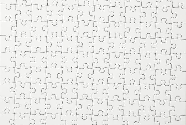 Close-up of blank white jigsaw puzzle texture background. Close-up and overhead shot of blank white jigsaw puzzle texture background. puzzle stock pictures, royalty-free photos & images
