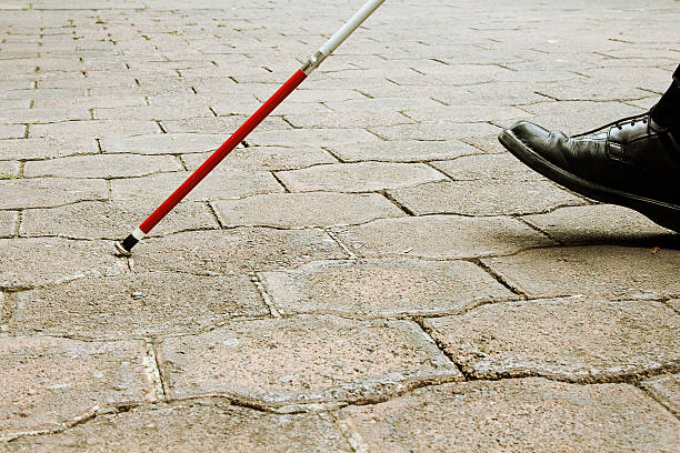 Closeup of Blind Man Walking With White Cane stock photo