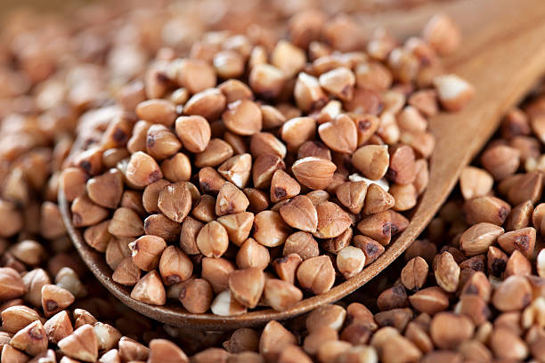 Close-up of buckwheat in a wooden spoon stock photo