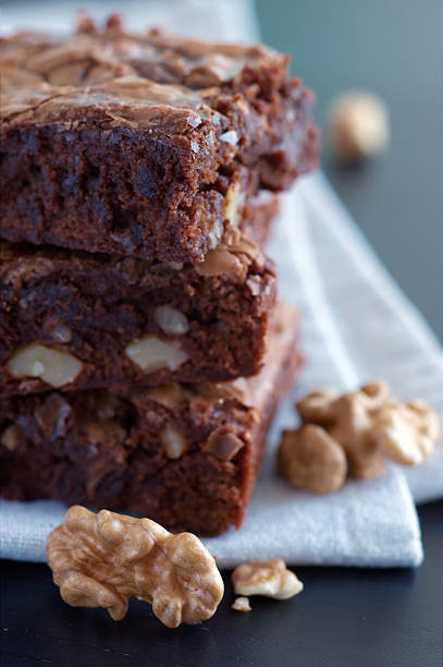 Close-up of chocolate brownies with walnuts on white cloth stock photo