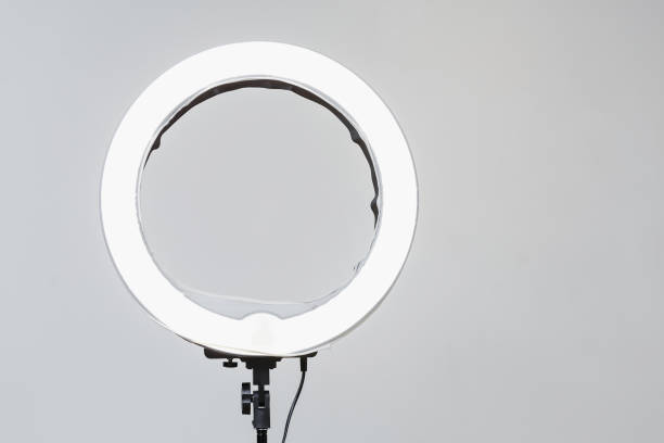 Closeup of circular neon LED lamp at white background. Popular modern light for make-up and beauty portraits Closeup of circular neon LED lamp at white background. Popular modern light for make-up and beauty portraits electric lamp photos stock pictures, royalty-free photos & images