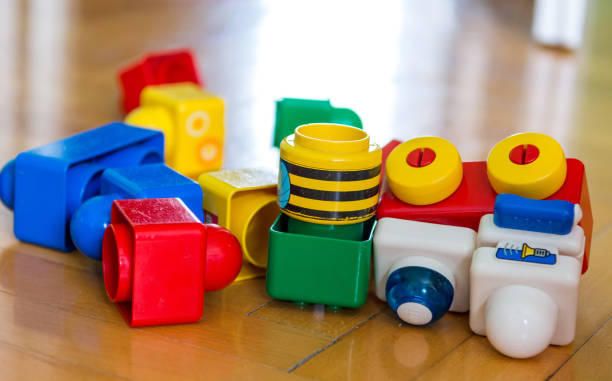 Closeup of colorful bricks on wooden floor. Closeup of colorful bricks on wooden floor. Didactic toys. nn girls stock pictures, royalty-free photos & images