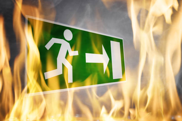 Close-up Of Emergency Evacuation Sign Close-up Of Emergency Evacuation Sign On Wall evacuation stock pictures, royalty-free photos & images