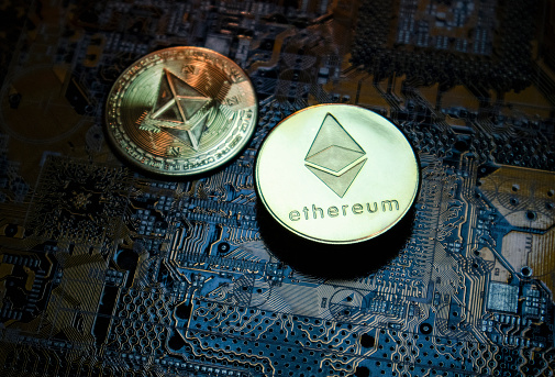 Antalya, Turkey - May 21, 2021: Close-up of Ethereum ETH cryptocurrency over computer circuit