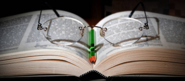 Close-up of Eyeglasses on open book stock photo