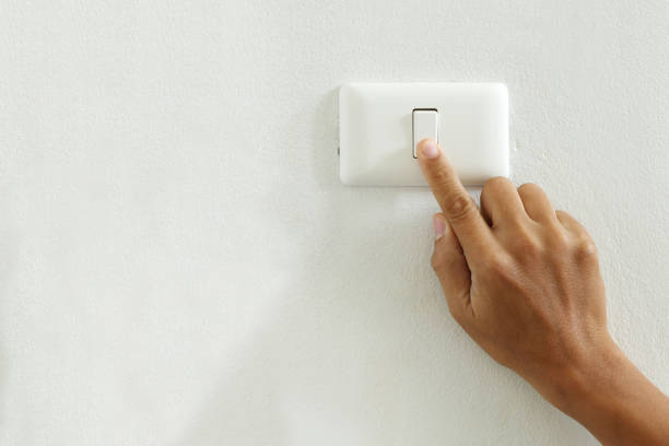 closeup of finger touching to electric switch off with copy space save energy concept closeup of finger touching to electric switch off with copy space light switch stock pictures, royalty-free photos & images