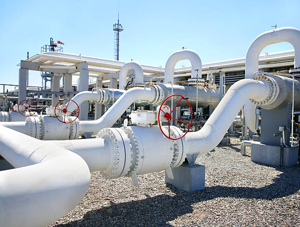 Close-up of giant white pipes at oil gas processing plant stock photo