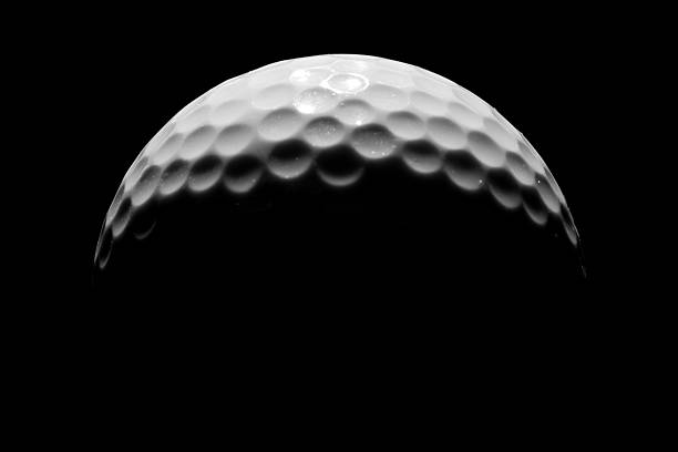 Close-up of Golf Ball on Black Background, Low Key stock photo