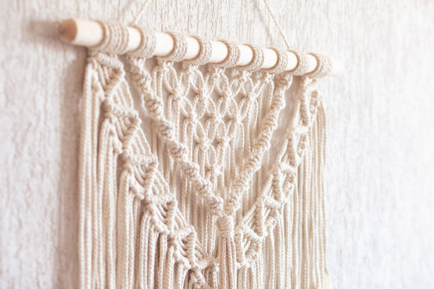 Close-up of hand made macrame texture pattern. ECO friendly modern knitting DIY natural decoration concept  in the interior.  Handmade macrame 100% cotton. Female hobby. stock photo
