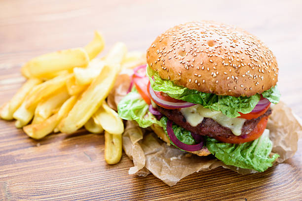 Closeup of home made burger with french fries. stock photo