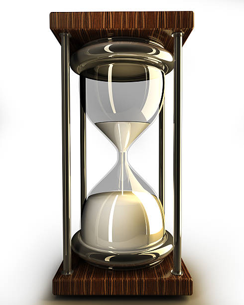closeup of hourglass in warm on white stock photo