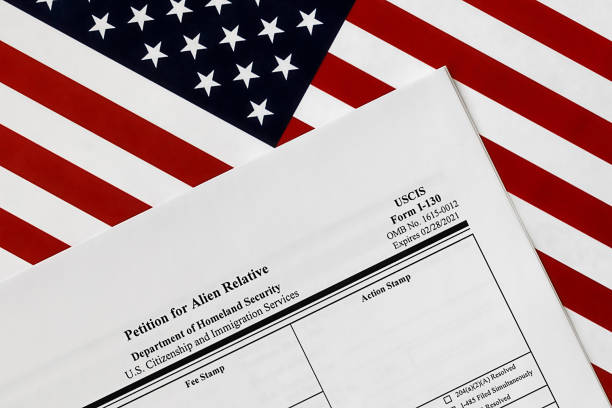 close-up of i-130 form. petition for alien relative topview, on a background of United States flag. stock photo
