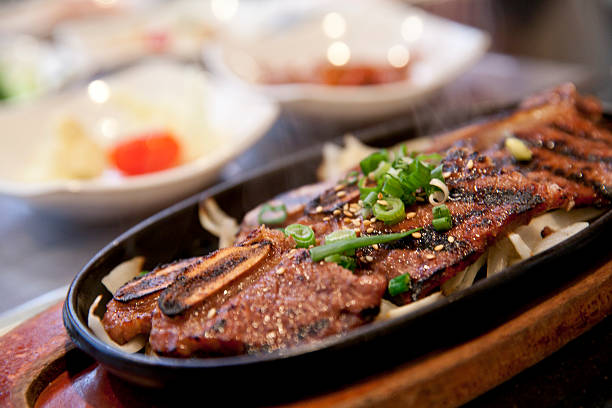 A close-up of Korean BBQ short ribs in a black dish stock photo