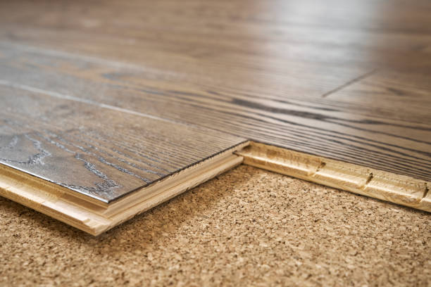 Close-up of laminate substrate and parquet board Parquet plank installation on cork. Renovate concept soundproof stock pictures, royalty-free photos & images