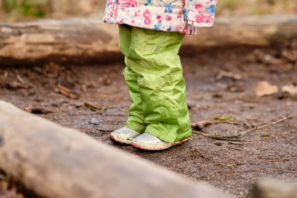 Close-up of low section of child girl standing in the forest stock photo