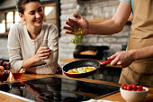 istock Close-up of man frying eggs with vegetables for breakfast. 1304775219