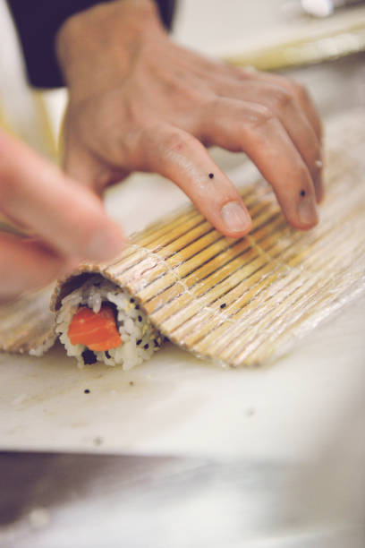 Close-Up Of Man Preparing Sushi stock photo